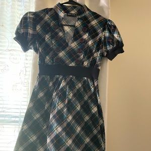 Cute paid dress with button detail.